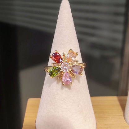 Joyería de flor de cinco pétalos con cristales dorados de colores